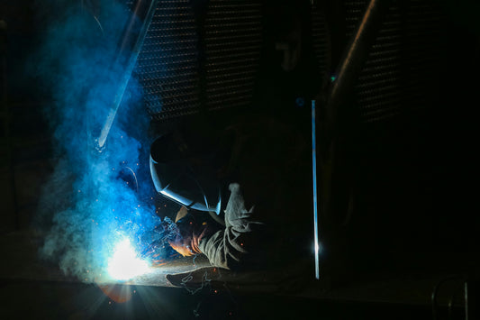 Man wearing safety gloves while hard at work.
